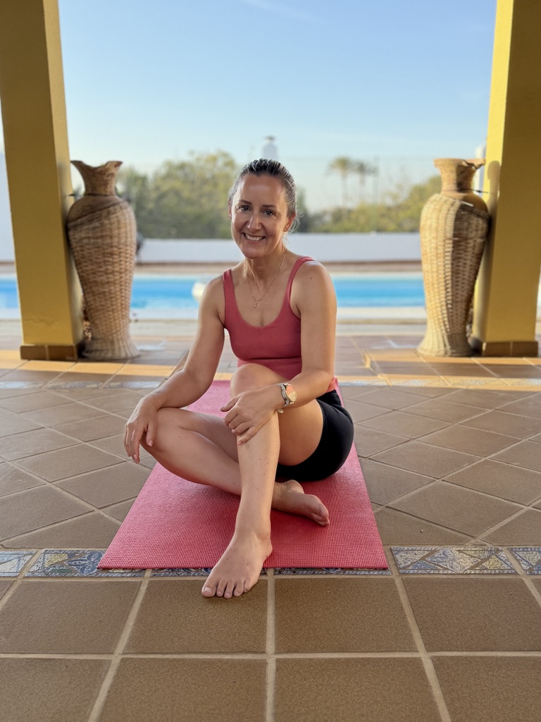 Georgina Loughrey sitting on an exercise mat